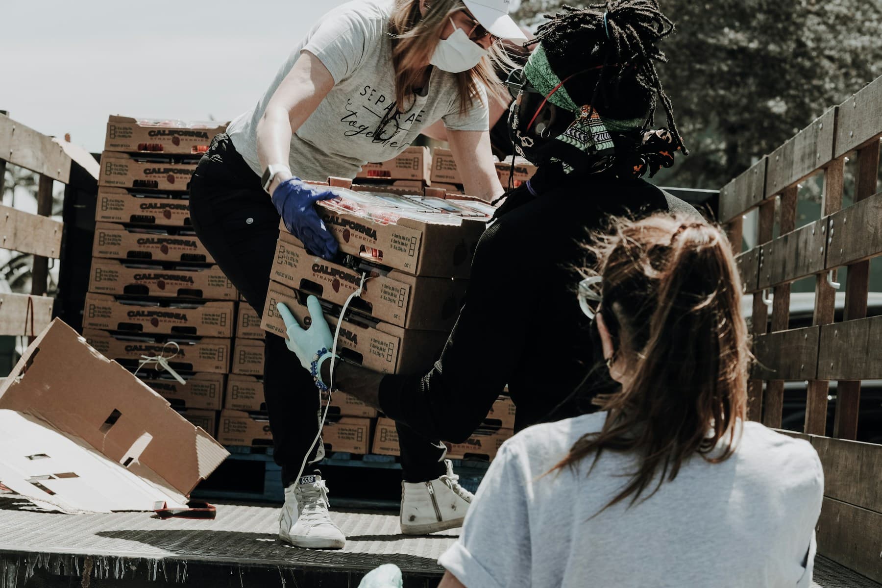 Volunteers preparing food parcels together at a community food bank
